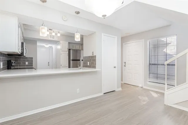 a view of a kitchen with a sink and cabinet area
