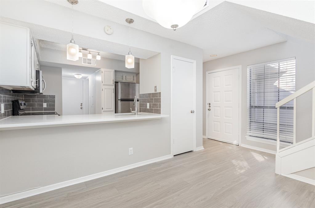 18240 Midway Road, Unit 204 Dallas, TX 75287 - Photo 10 of 21 a view of a kitchen with a sink and cabinet area