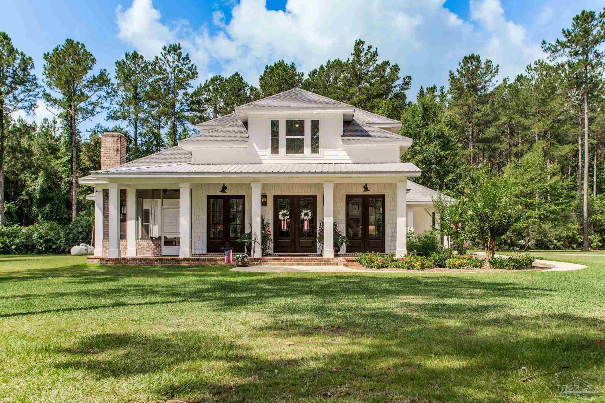 a front view of a house with a garden