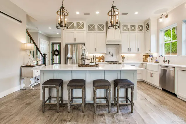 a large kitchen with a table and chairs in it