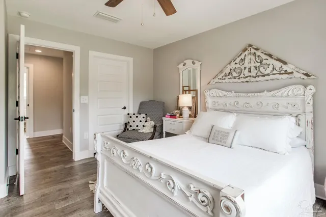 a bedroom with a bed and a mirror