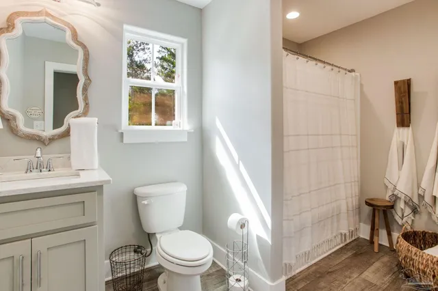 a bathroom with a toilet sink and a mirror