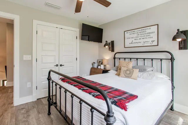 a bedroom with a bed and a flat screen tv