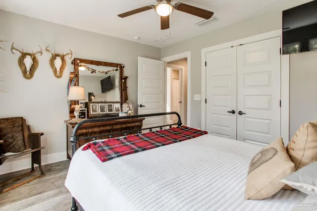 a bedroom with a bed and a chandelier