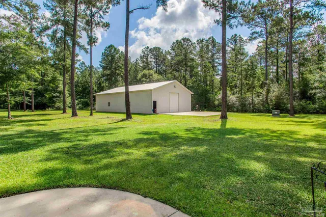 a view of a house with a backyard