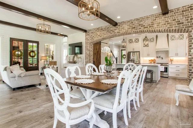 a view of a dining room with furniture wooden floor and chandelier