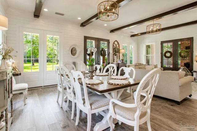 a view of a dining room with furniture wooden floor and chandelier
