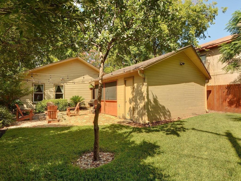 610 West N Loop Boulevard Austin, TX 78751 - Photo 22 of 29 The property features a spacious lawn, a paved patio area, and mature trees providing shade