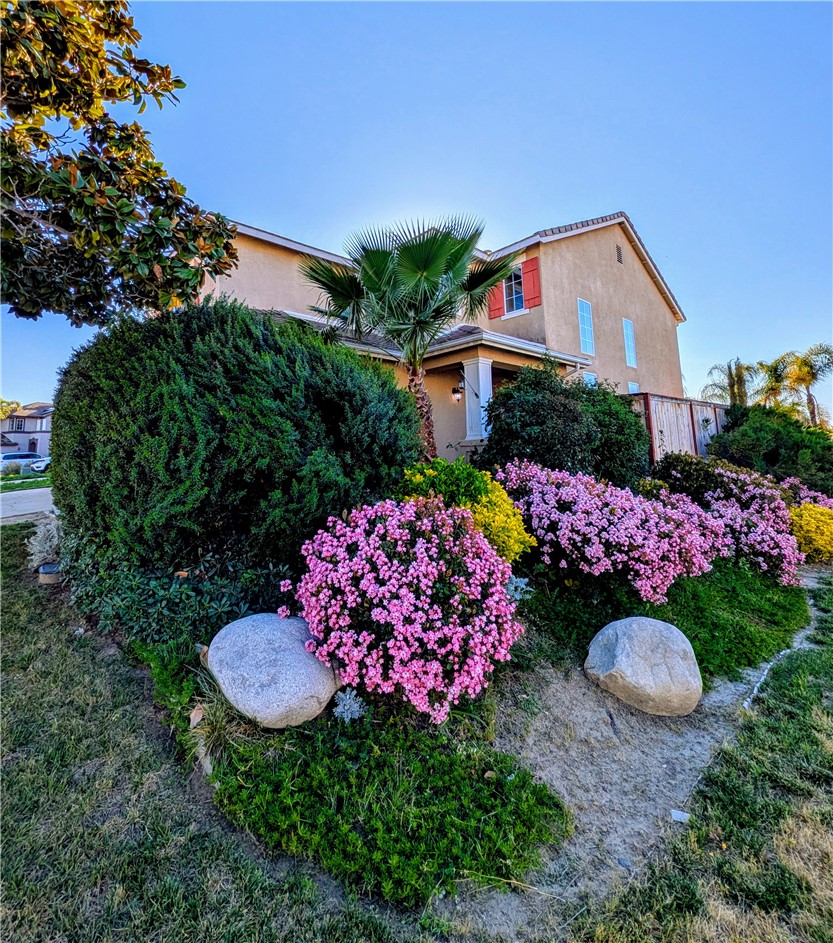 a house view with a chair and table in the garden