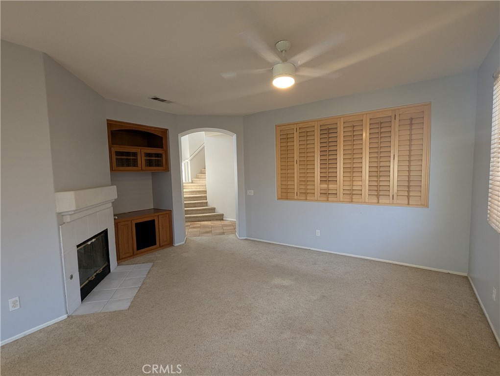 44601 Crestwood Circle Temecula, CA 92592 - Photo 12 of 46 an empty room with a fireplace and window