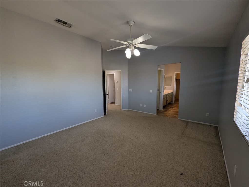 44601 Crestwood Circle Temecula, CA 92592 - Photo 26 of 46 an empty room with a window and a ceiling fan
