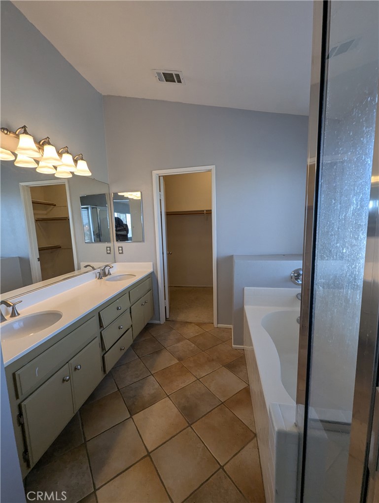44601 Crestwood Circle Temecula, CA 92592 - Photo 28 of 46 a spacious bathroom with a double vanity sink and a mirror