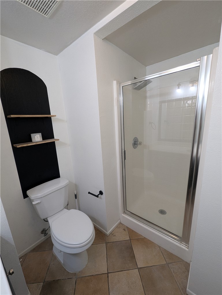 44601 Crestwood Circle Temecula, CA 92592 - Photo 32 of 46 a bathroom with a toilet and a shower