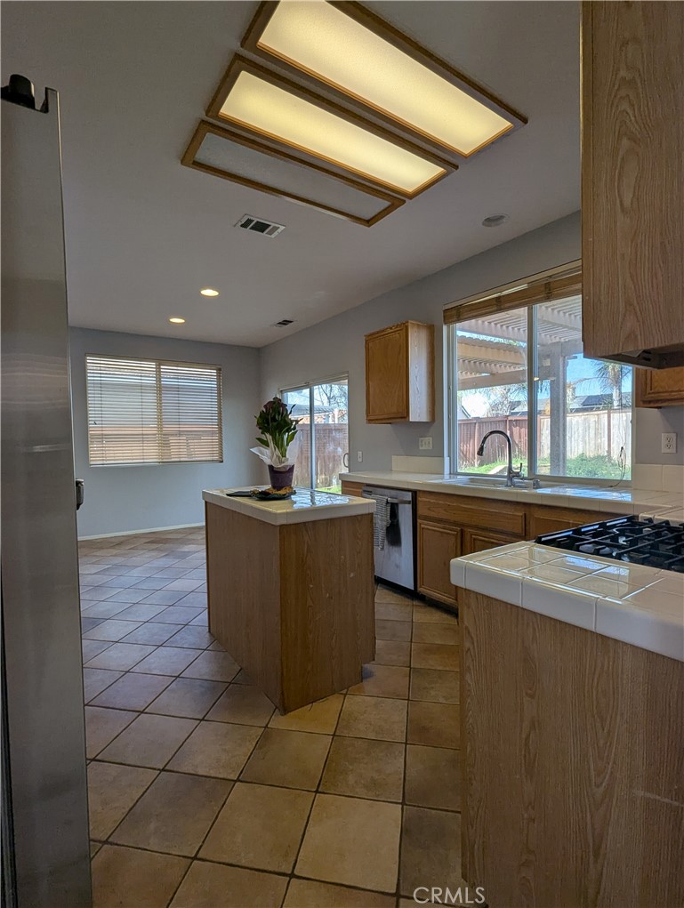 44601 Crestwood Circle Temecula, CA 92592 - Photo 10 of 46 a kitchen with stainless steel appliances granite countertop a sink and a stove