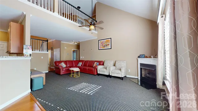 a living room with furniture a fireplace and a window