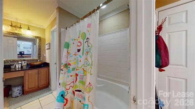 a bathroom with a bathtub and a shower curtain