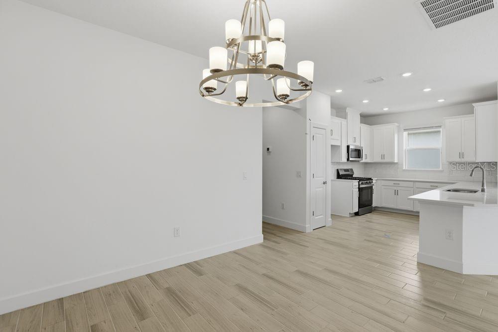 5375 Spoonflower Court St. Cloud, FL 34771 - Photo 13 of 42 a view of a kitchen with a sink wooden cabinet and stainless steel appliances