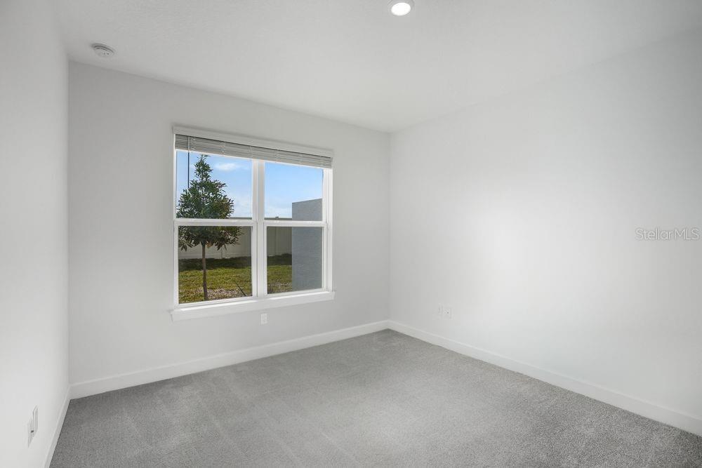 5375 Spoonflower Court St. Cloud, FL 34771 - Photo 17 of 42 an empty room with a window