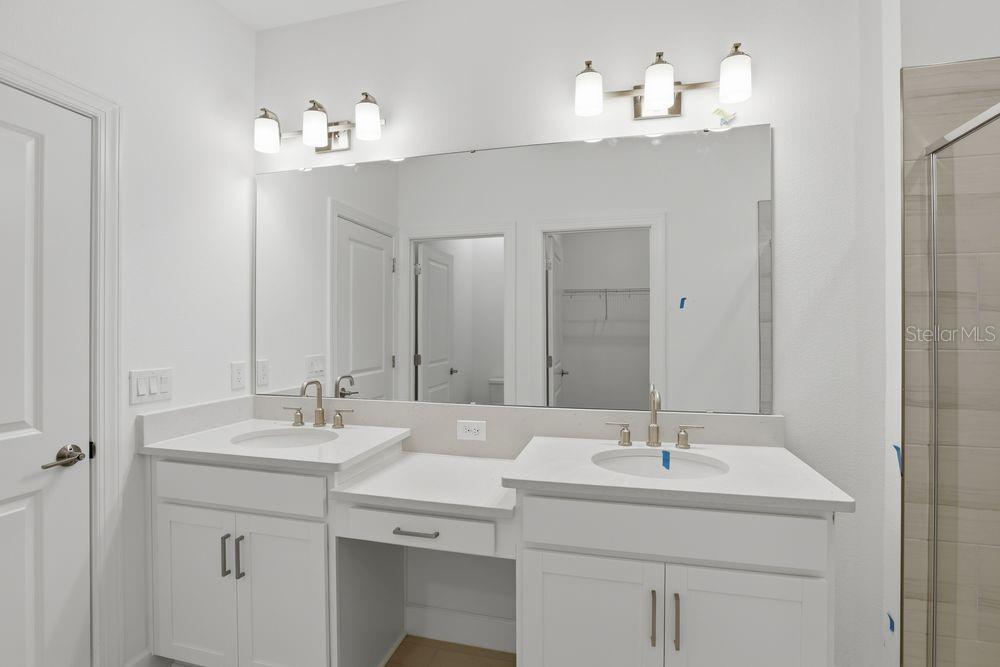 5375 Spoonflower Court St. Cloud, FL 34771 - Photo 20 of 42 a bathroom with a sink double vanity and a mirror