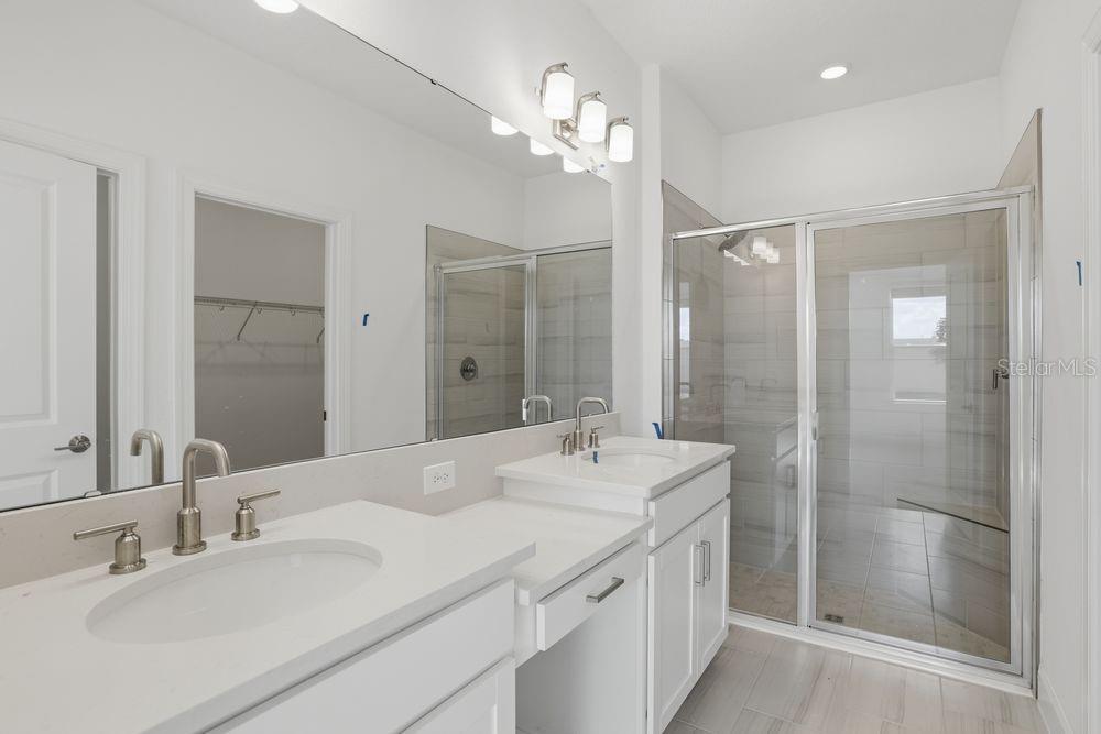 5375 Spoonflower Court St. Cloud, FL 34771 - Photo 22 of 42 a bathroom with a double vanity sink mirror and shower