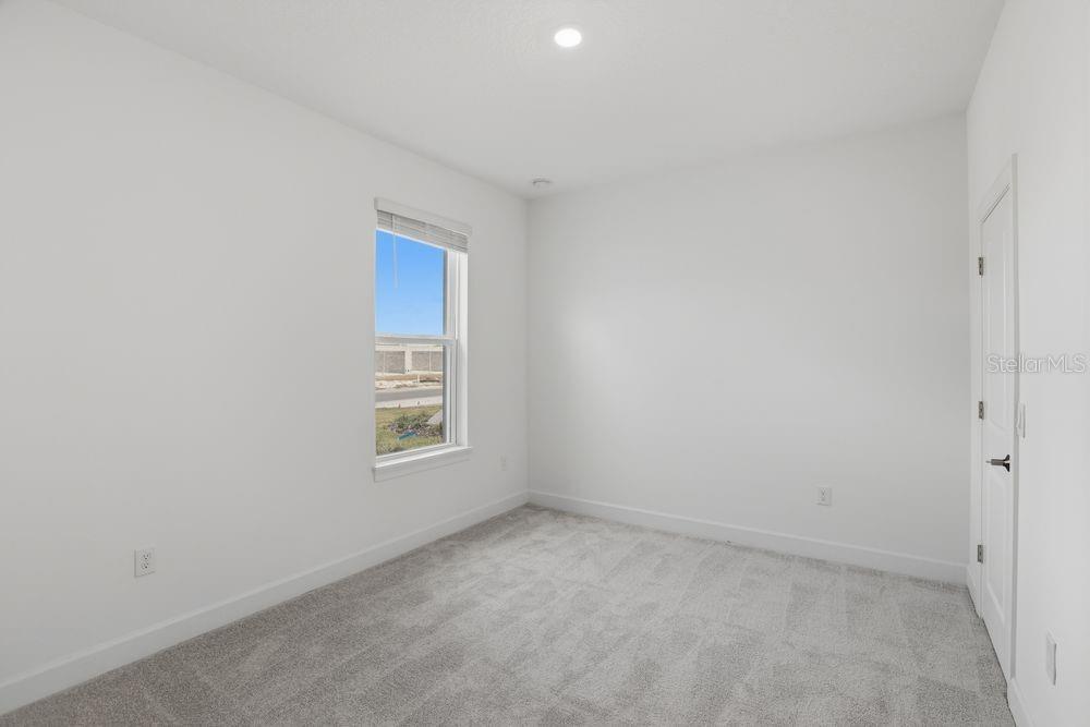 5375 Spoonflower Court St. Cloud, FL 34771 - Photo 24 of 42 a view of an empty room with a window