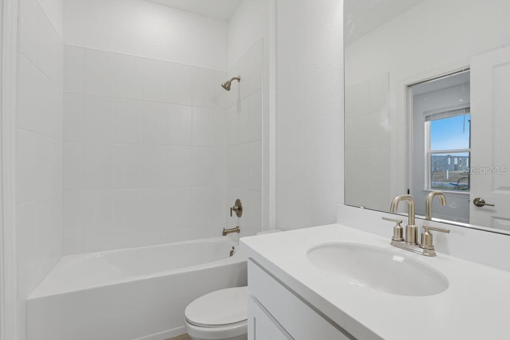 5375 Spoonflower Court St. Cloud, FL 34771 - Photo 26 of 42 a bathroom with a sink toilet and bathtub