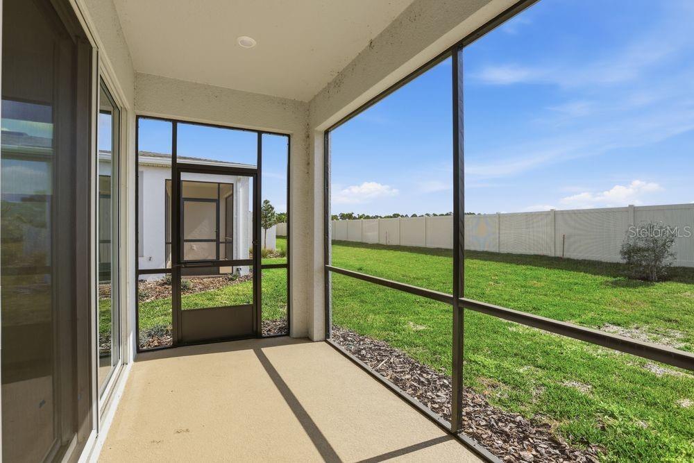 5375 Spoonflower Court St. Cloud, FL 34771 - Photo 28 of 42 a view of backyard with floor to ceiling window and wooden fence