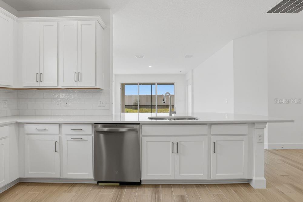 5375 Spoonflower Court St. Cloud, FL 34771 - Photo 4 of 42 a kitchen with white cabinets