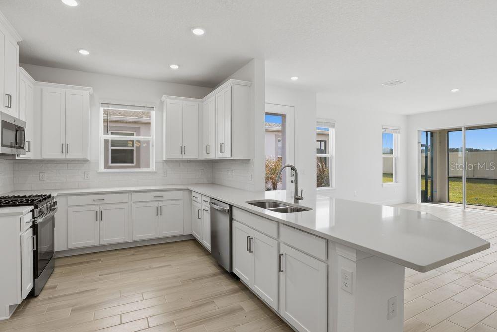 5375 Spoonflower Court St. Cloud, FL 34771 - Photo 7 of 42 a kitchen with sink cabinets and window