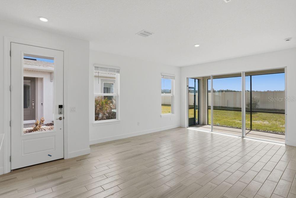 5375 Spoonflower Court St. Cloud, FL 34771 - Photo 8 of 42 wooden floor in an empty room with a window