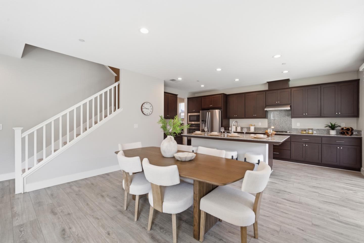6430 Godani Street Gilroy, CA 95020 - Photo 11 of 38 a kitchen with a dining table chairs wooden floor appliances and cabinets