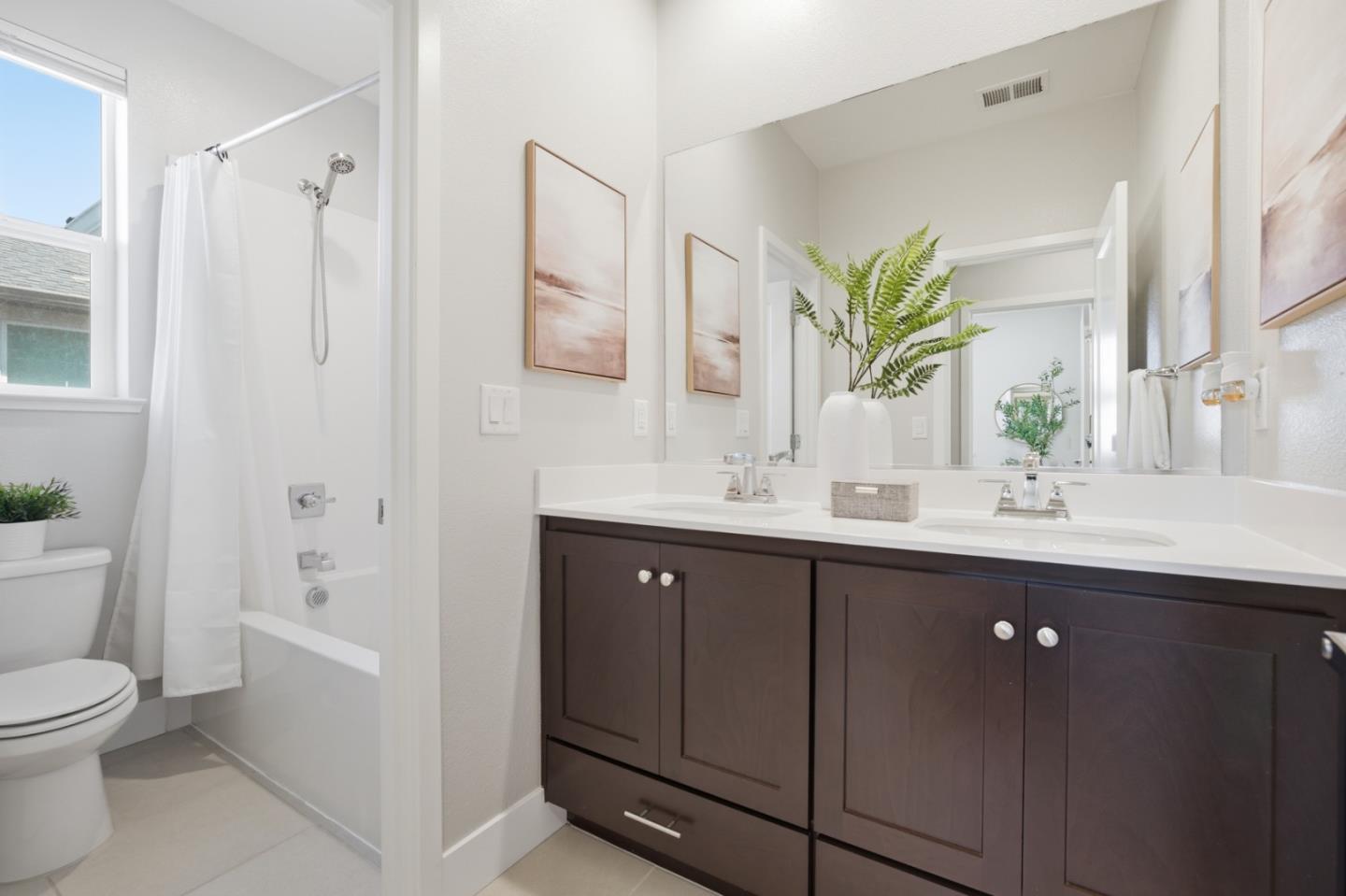 6430 Godani Street Gilroy, CA 95020 - Photo 22 of 38 a bathroom with a double vanity sink toilet and shower