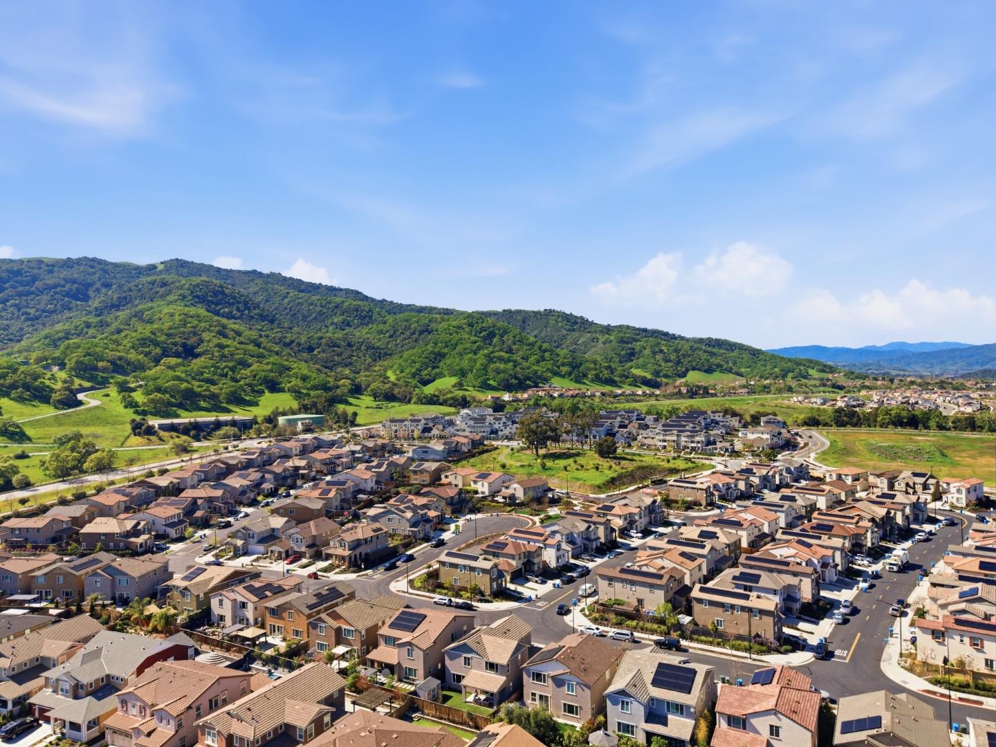 6430 Godani Street Gilroy, CA 95020 - Photo 36 of 38 an aerial view of a city with lots of residential buildings and mountain view in back