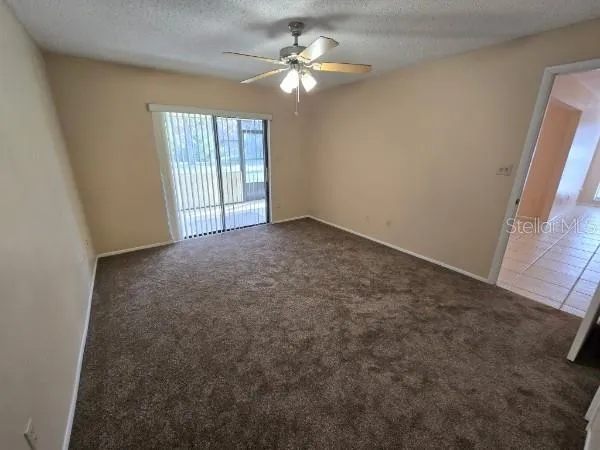 a view of a room with a ceiling fan and a next to a window