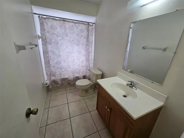 a bathroom with a sink mirror vanity and toilet