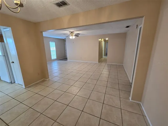 a view of an empty room and a bathroom