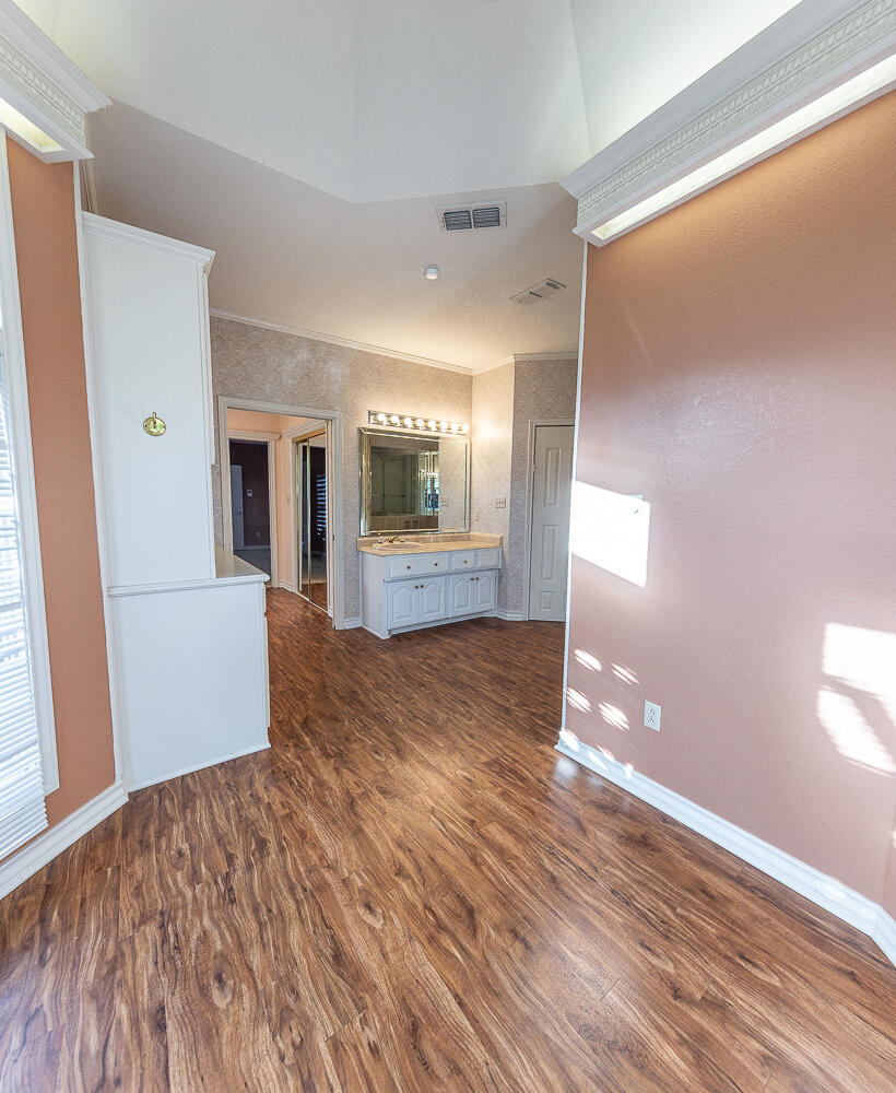 6604 3rd Street Lubbock, TX 79416 - Photo 19 of 46 a view of a hallway with wooden floor and a living room