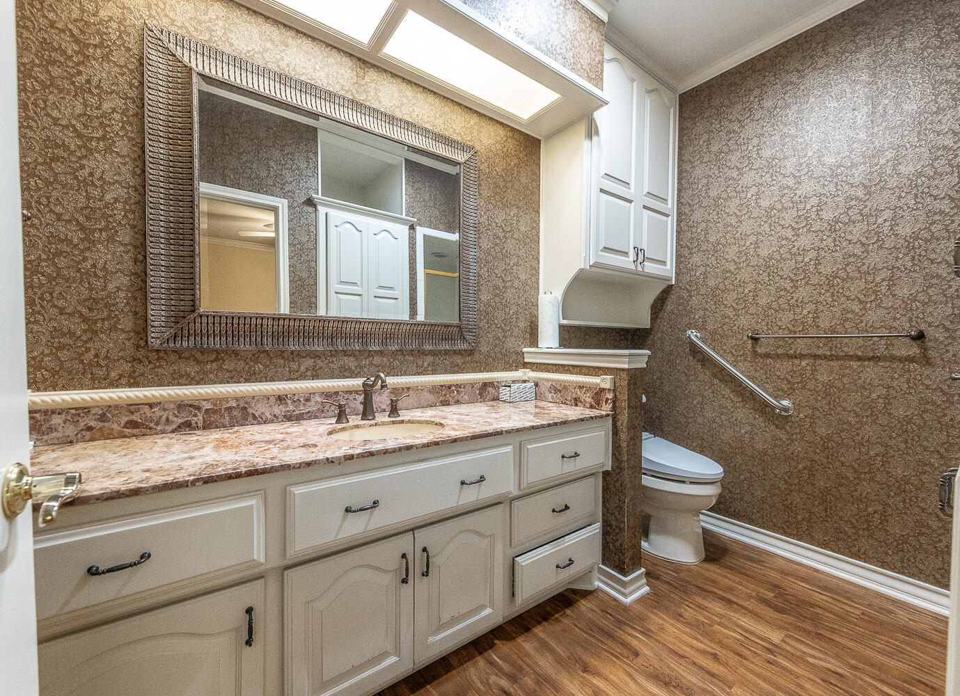 6604 3rd Street Lubbock, TX 79416 - Photo 22 of 46 a bathroom with a granite countertop toilet sink and mirror