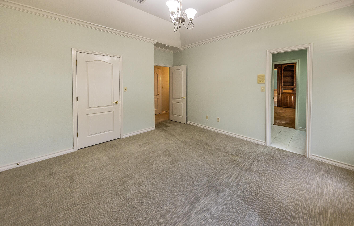 6604 3rd Street Lubbock, TX 79416 - Photo 24 of 46 a view of an empty room with a chandelier