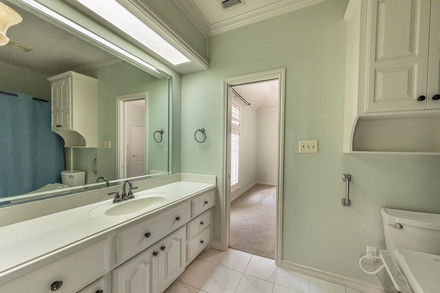6604 3rd Street Lubbock, TX 79416 - Photo 25 of 46 a bathroom with a double vanity sink mirror and shower