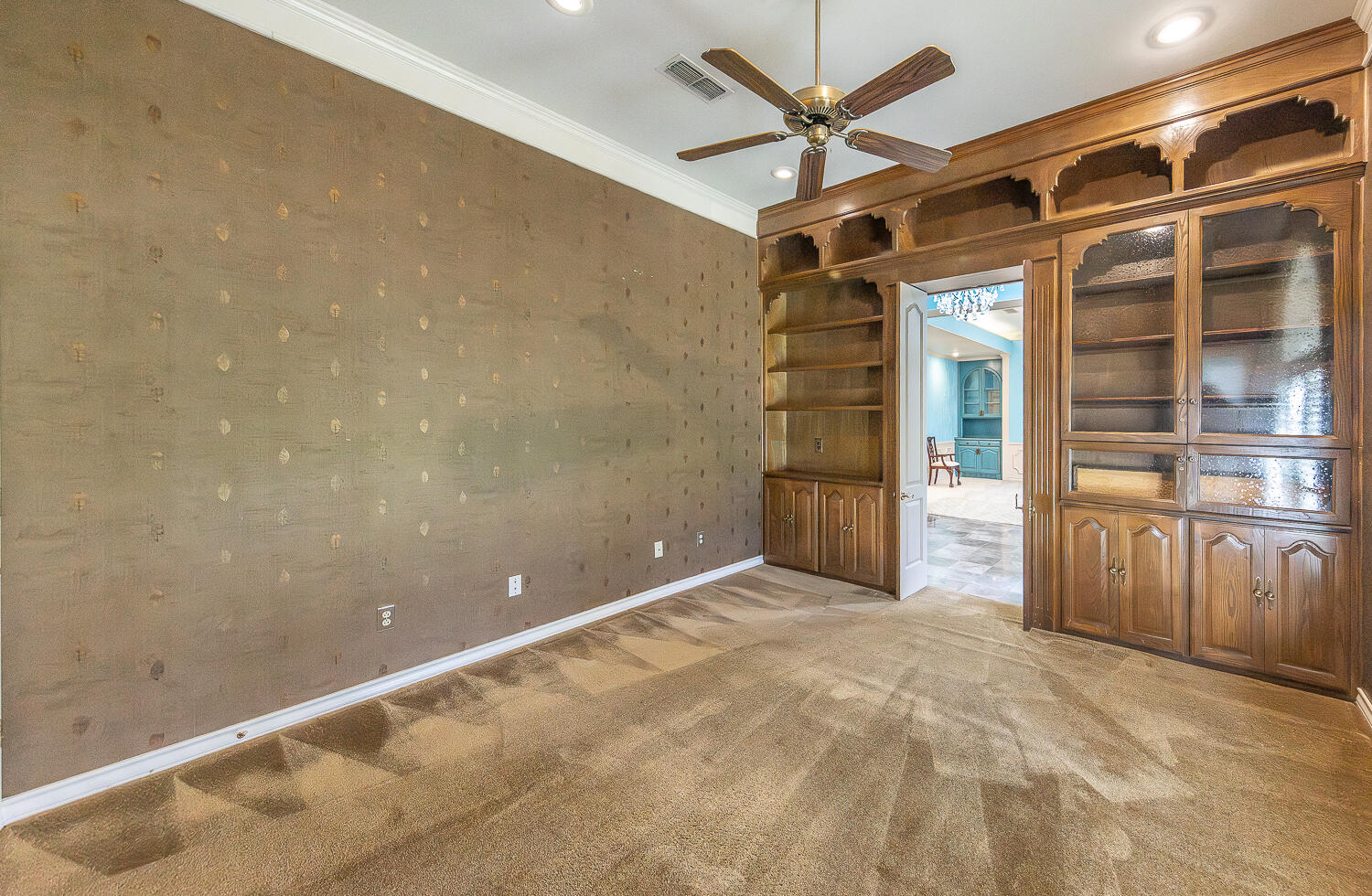 6604 3rd Street Lubbock, TX 79416 - Photo 27 of 46 a view of a livingroom with a ceiling fan and wooden floor