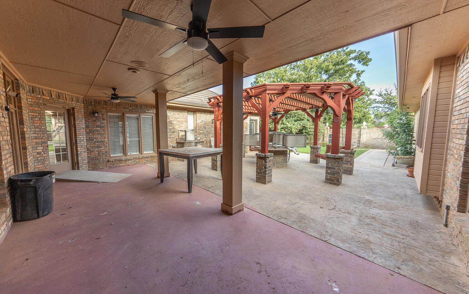 6604 3rd Street Lubbock, TX 79416 - Photo 29 of 46 a view of a porch with chairs and backyard