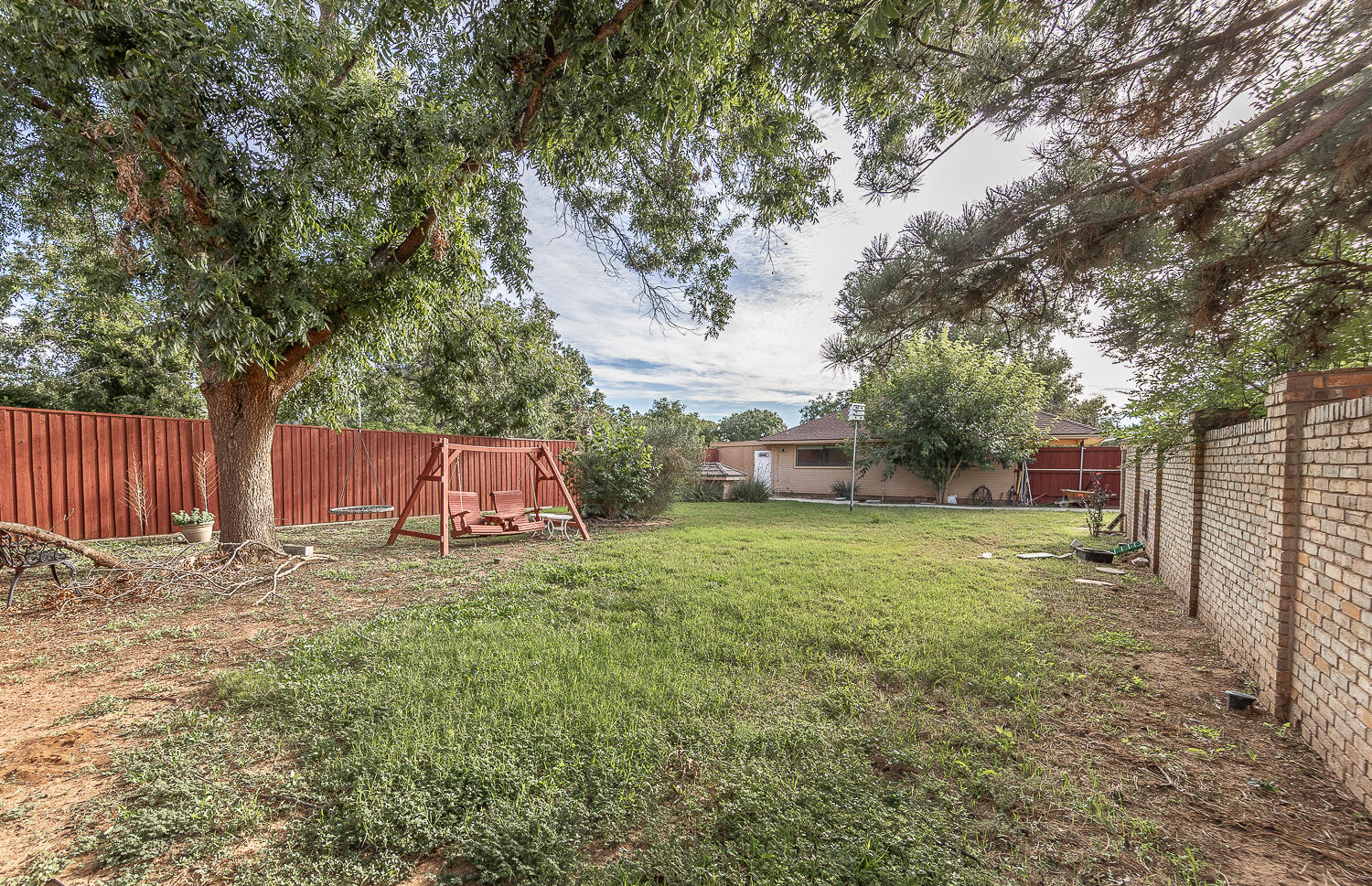 6604 3rd Street Lubbock, TX 79416 - Photo 34 of 46 a backyard of a house with a trees and outdoor seating