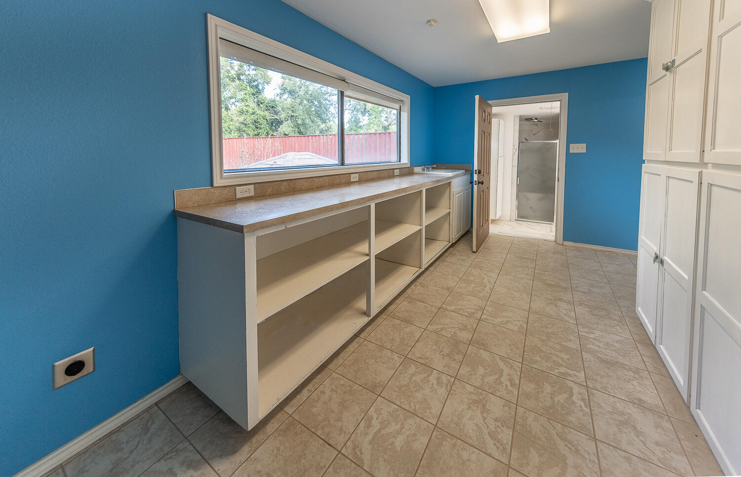 6604 3rd Street Lubbock, TX 79416 - Photo 36 of 46 a view of a kitchen with a sink and dishwasher next to a window