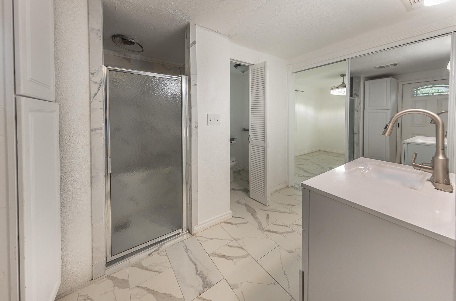6604 3rd Street Lubbock, TX 79416 - Photo 40 of 46 a bathroom with a sink shower and a mirror