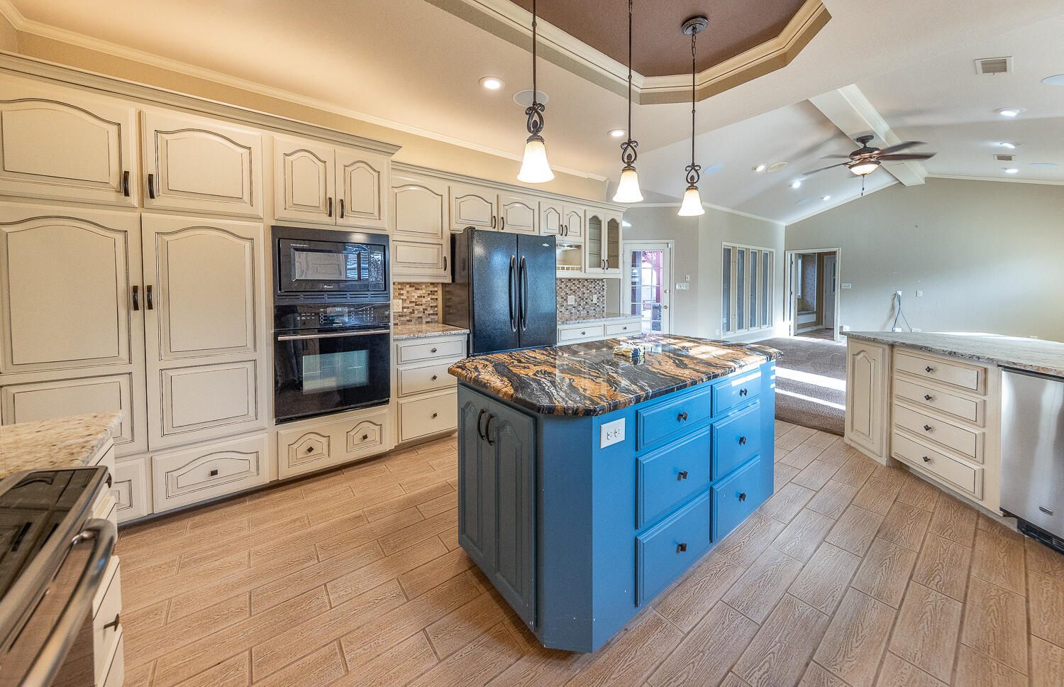 6604 3rd Street Lubbock, TX 79416 - Photo 10 of 46 a kitchen with stainless steel appliances granite countertop a large stove a sink dishwasher and refrigerator with wooden floor