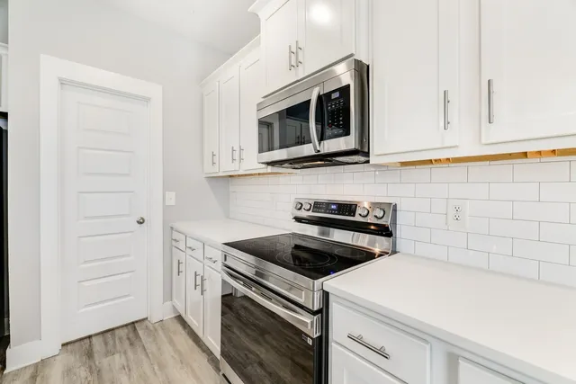 a kitchen with a sink and wooden floor