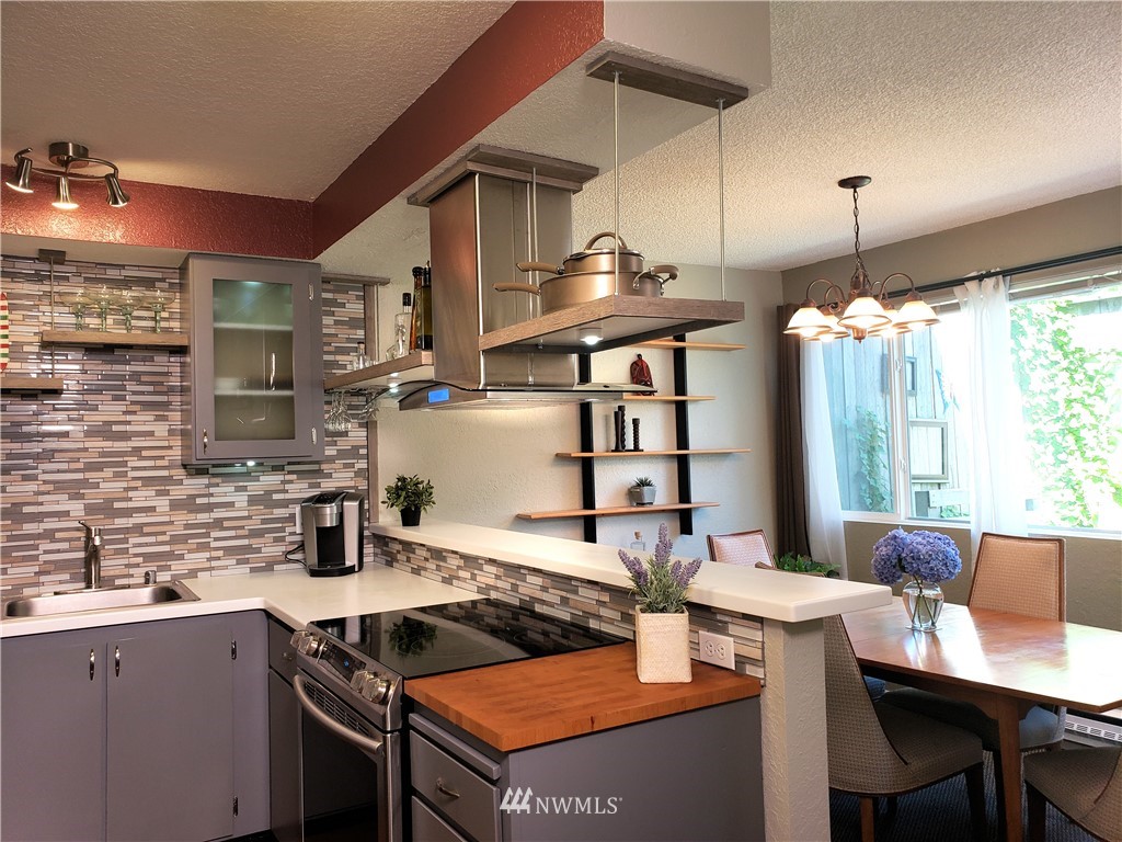 8401 25th Avenue Southwest, Unit B Seattle, WA 98106 - Photo 3 of 10 a kitchen with a stove a sink and cabinets