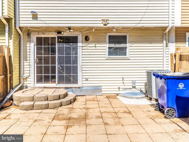 a view of a small yard with wooden fence and trees