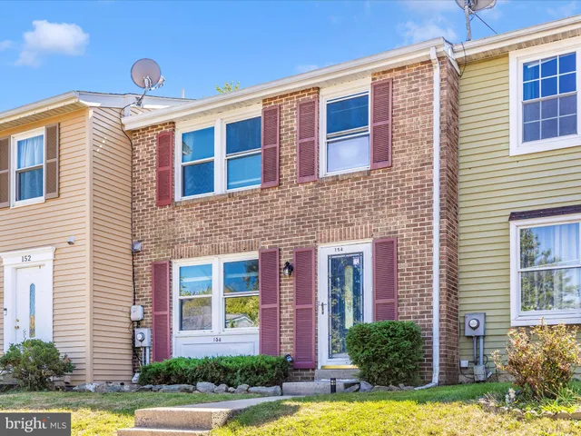 a front view of a house with yard and green space